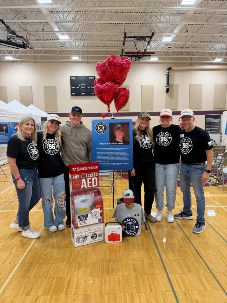 Volunteers with the donated SAVESTATION and AED